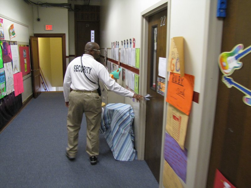 Christopher Sims, a security officer at Pulaski Heights Elementary School, checks doors during a round Monday afternoon.