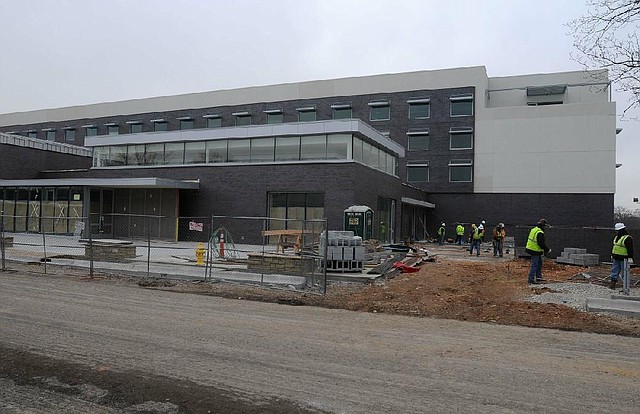 Construction crews continue to work Monday on the 21c Museum Hotel in downtown Bentonville. The hotel is accepting reservations on or after March 10 for its 104 guest rooms.