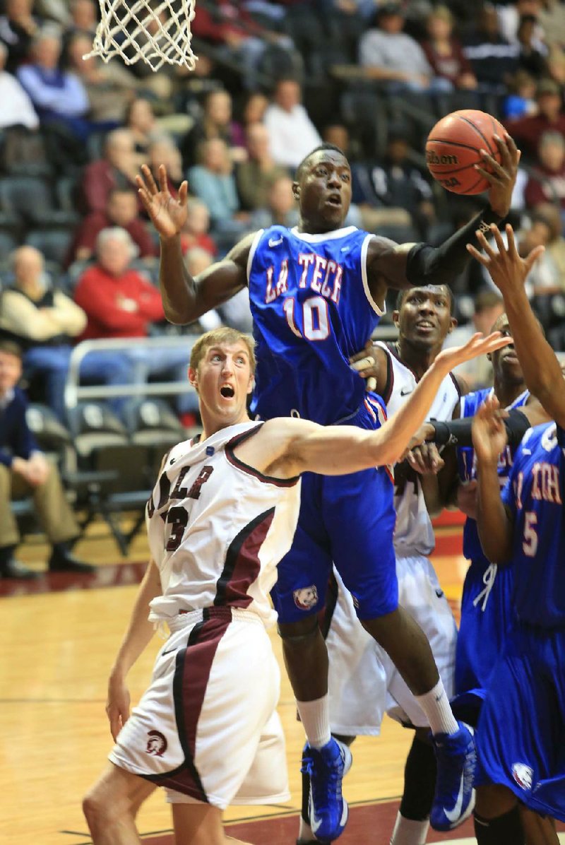 Louisiana Tech forward Isaiah Massey (10) pulls down a rebound over UALR forward Will Neighbour (53) during Monday’s game at the Jack Stephens Center in Little Rock. Neighbour finished with 7 points, 5 rebounds and 1 block as the Trojans lost 75-73.