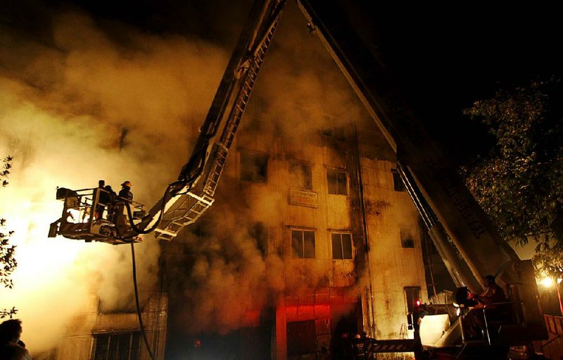 A government panel believes that this Nov. 24 garment factory fire in Dhaka, Bangladesh, that killed 112 people was set by a saboteur who was possibly a worker at the factory, which manufactured clothing for several large U.S. retailers. The blaze set off a sharp debate about who should bear the cost to ensure worker safety.