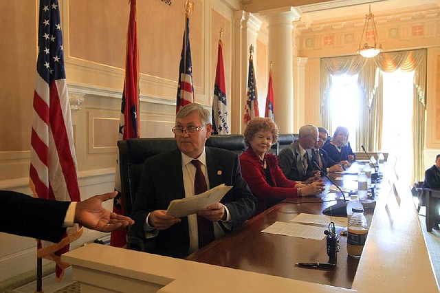 Jonathan Barnett (holding papers), Reta Hamilton and four other Republican electors meet at the state Capitol in Little Rock on Monday and cast the state’s six electoral votes for Republicans Mitt Romney and Paul Ryan. Similar meetings were held in capitals across the country.