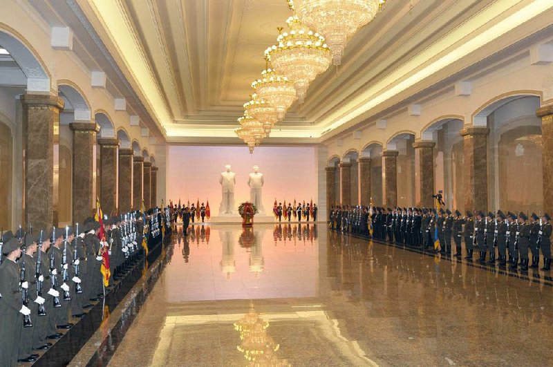 A military guard of honor participates in the ceremony to reopen the mausoleum in Pyongyang, North Korea, where former North Korean leader Kim Jong Il’s embalmed remains will lie in state in this photo released by the Korean Central News Agency on Monday, the anniversary of his death.