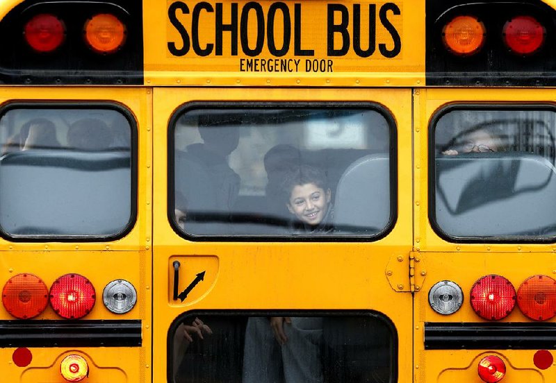 A smiling student arrives Tuesday at Hawley School in Newtown, Conn. 