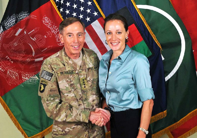 Gen. David Petraeus, the former commander of coalition and U.S. forces in Afghanistan, shakes hands with Paula Broadwell, in this July 13, 2011, photo made available on the International Security Assistance Force’s Flickr website. 