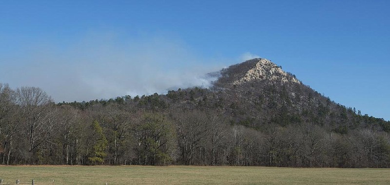 Arkansas Democrat-Gazette/KAREN E. SEGRAVE --12/18/12 -- Light smoke billows from the west side of Pinnacle Mountain on Tuesday afternoon.  A portion of Pinnacle Mountain was under a controlled burn and the smoke could be seen for miles.