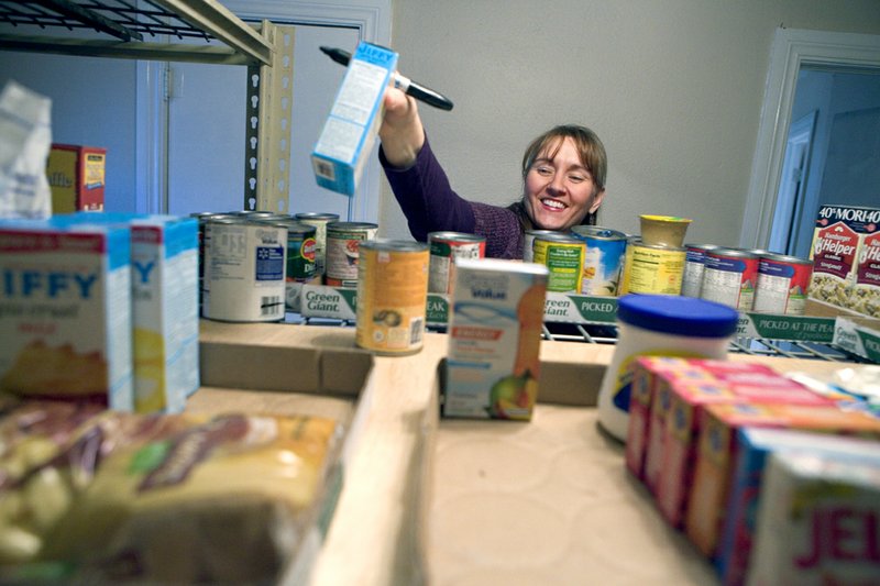 Lisa Barber sorts food at the Pottsville Community Pantry. The pantry, which opened after another local pantry closed, is holding food distributions the third Friday of every month, rotating among three churches.