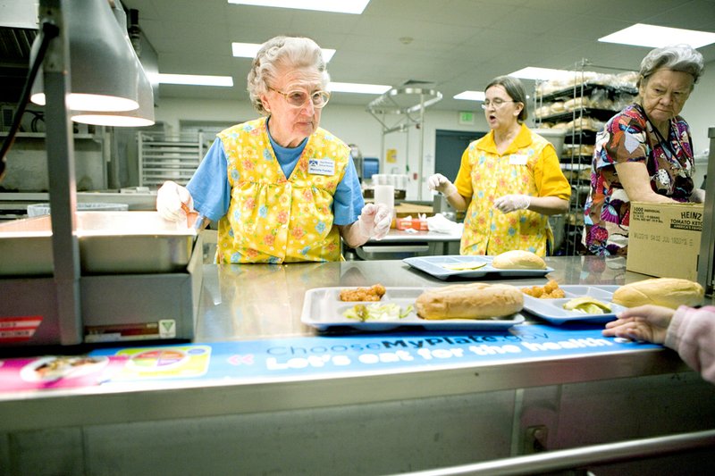 Marcelle Fielder serves lunch to students at Guy-Perkins School District's cafeteria. Fielder is in her 35th year of working at the schools’ cafeteria, which is going to be named after her.