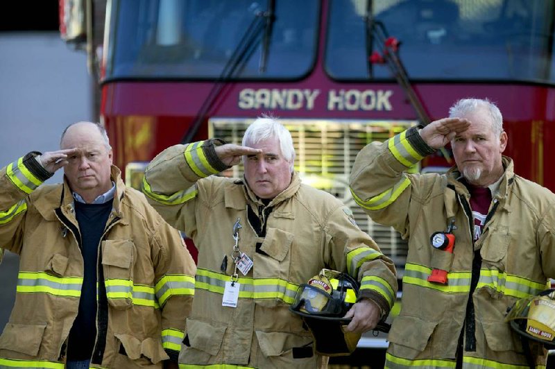 Firefighters salute as a hearse passes for the funeral procession to the burial of 7-year-old Sandy Hook Elementary School shooting victim Daniel Gerard Barden, Wednesday, Dec. 19, 2012, in Newtown, Conn. Barden was killed when Adam Lanza walked into Sandy Hook Elementary School in Newtown, Conn., Dec. 14, and opened fire, killing 26 people, including 20 children, before killing himself.(AP Photo/David Goldman)