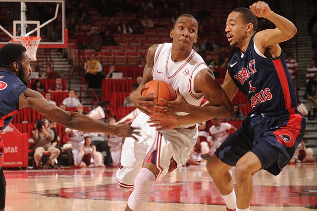 Arkansas sophomore guard BJ Young drives to the lane as Robert Morris junior guard Caron Williams applies pressure during the first half Thursday, Dec. 20, 2012, in Bud Walton Arena in Fayetteville.