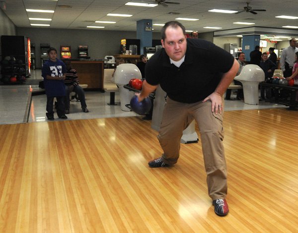 Staff Sgt. Olin Rankin with the Benton County Sheriff’s Office bowls Wednesday at the Rogers Bowling Center with youth from the Sheriff’s Office Police Athletic League. 