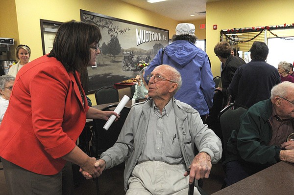 Susan Moore, left, with the Office of Human Concern, greets lifelong Lowell resident Elza Tucker on Wednesday at the new J.B. Hunt Transport Senior Activity Center in Lowell. 