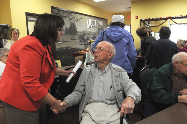 Susan Moore, left, with the Office of Human Concern, greets lifelong Lowell resident Elza Tucker on Wednesday at the new J.B. Hunt Transport Senior Activity Center in Lowell. 