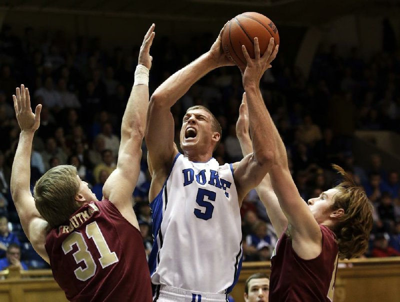 Duke forward Mason Plumlee (5) shoots in front of Ryley Beaumont during the ÿrst half of Thursday’s game in Durham, N.C. Plumlee ÿ nished with 21 points and 15 rebounds as No. 1 Duke beat Elon 76-54. 