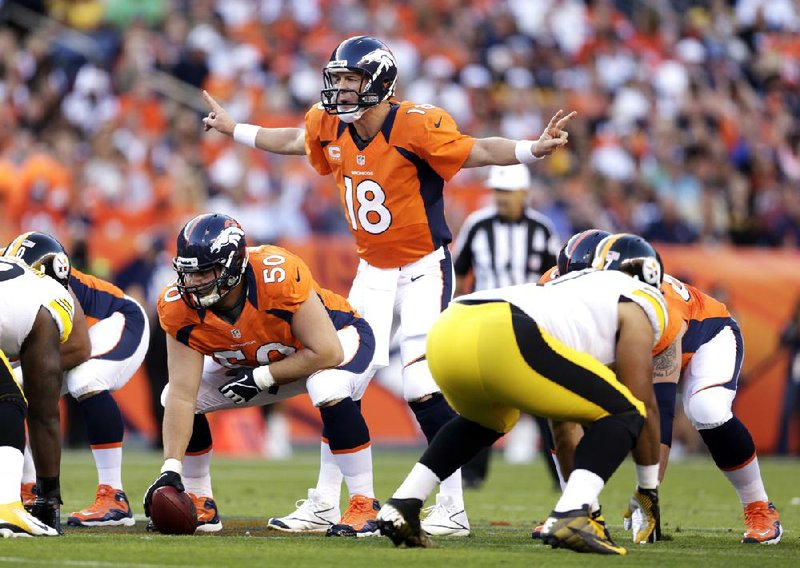 Denver Broncos quarterback Peyton Manning signals to teammates during a Sept. 9 game against the Pittsburgh Steelers. Every game, two of his interior offensive linemen are miked up for network TV, bringing the sounds of his pre-snap routine to millions of viewers, as well as future opponents. 