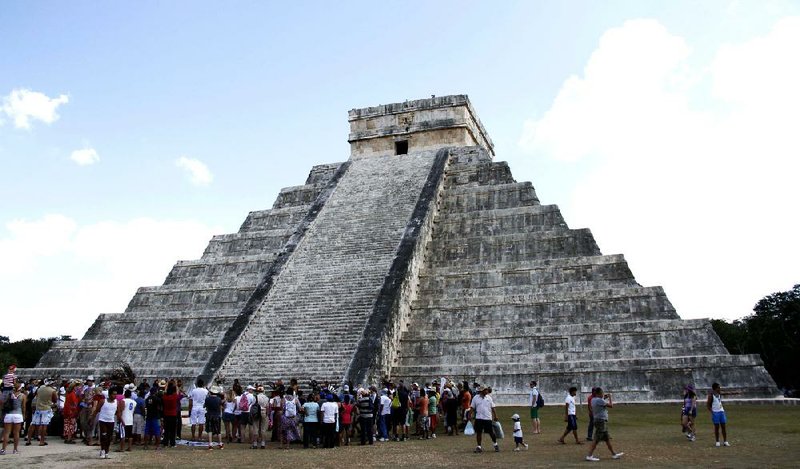 People gather Thursday in front of the Kukulkan Pyramid in Chichen Itza, Mexico, where American seer Star Johnsen-Moser led a whooping, dancing and drum-beating ceremony. 