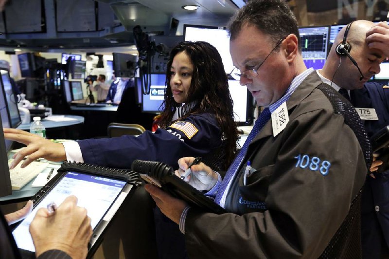 Specialist Wingszi Chiang directs trading Thursday at her post on the floor of the New York Stock Exchange. 