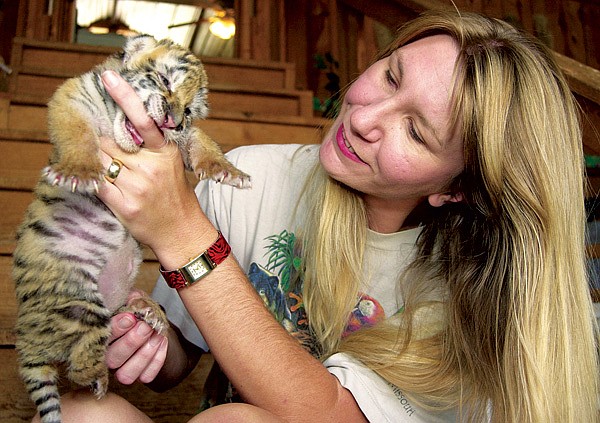 Tanya Smith, one of the founders of Turpentine Creek Wildlife Refuge near Eureka Springs, greets a new arrival.