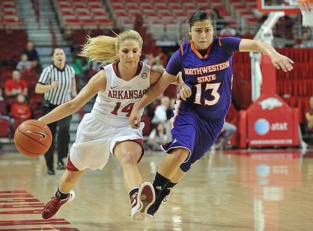 NWA Media/MICHAEL WOODS --12/21/2012-- Arkansas' Erin Gatling tries to get the ball past Northwestern State defender Janelle Perez as she drives to the hoop in the first half of Friday night's game at Bud Walton Arena in Fayetteville.