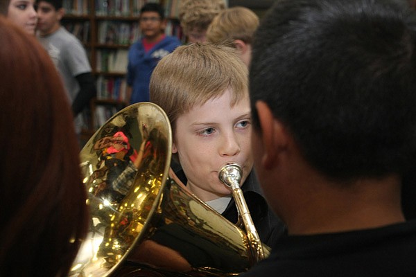 Robert Townsend, a sixth-grader, plays a note Thursday in his role as Titanic band leader during the Living History Museum. 