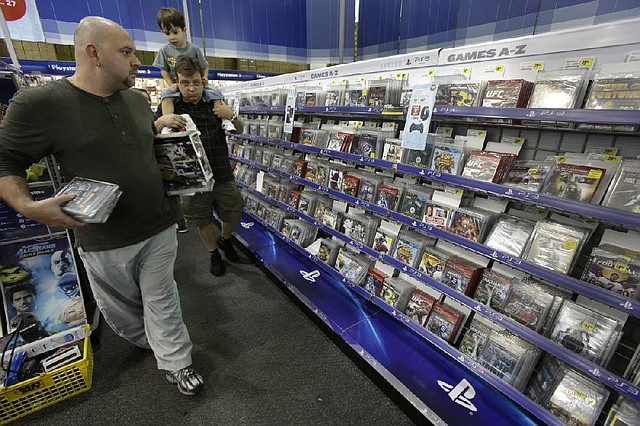 Shoppers look for bargains Thursday in the video games section of a Best Buy store in Orlando, Fla. Consumer spending is on the rebound, a New York economist said. 