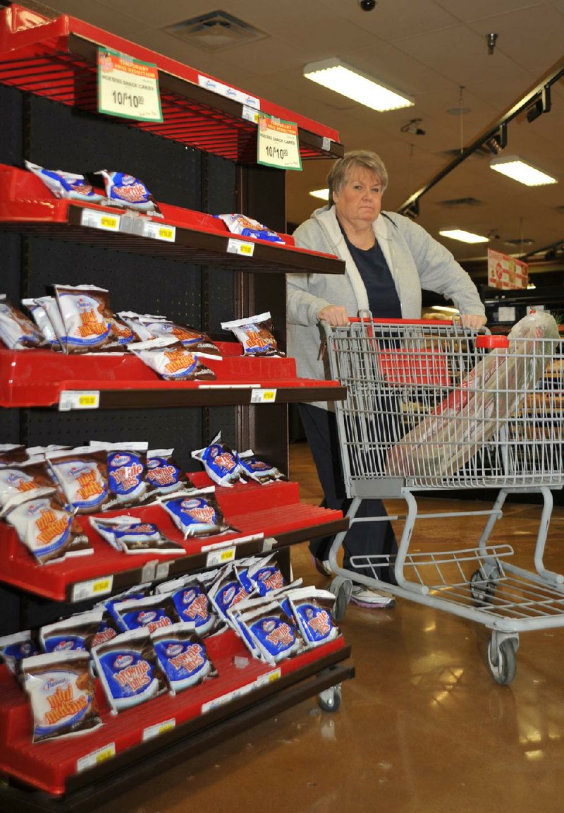 Faye Crawford passes a rack of Hostess products on Nov. 24 at a grocery store in Jonesboro. 