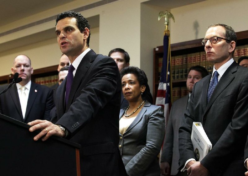 Treasury Undersecretary David Cohen, left, talks to reporters Dec. 11 about British bank HSBC’s agreement to pay $1.9 billion to settle a New York-based probe. Cohen was joined by U.S. Attorney for the Eastern District of New York Loretta Lynch, center, and Lanny Breuer, right, assistant attorney general of the Justice Department's Criminal Division. 