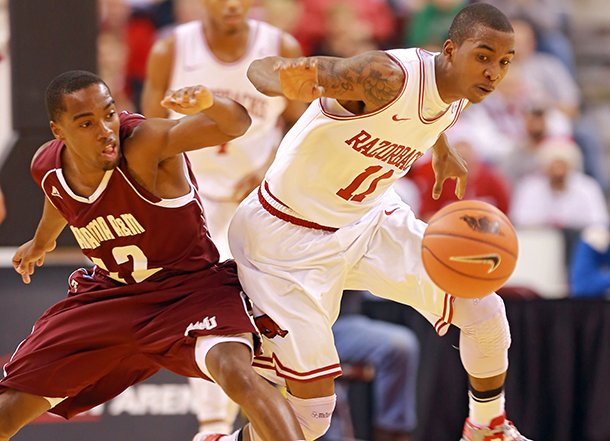Arkansas Democrat-Gazette/STEPHEN B. THORNTON -- Alabama A&M's Green Hill, left, and Arkansas' BJ Young battle for a loose ball after Young stripped it during the first half of their game Saturday night at Verizon Arena in North Little Rock.