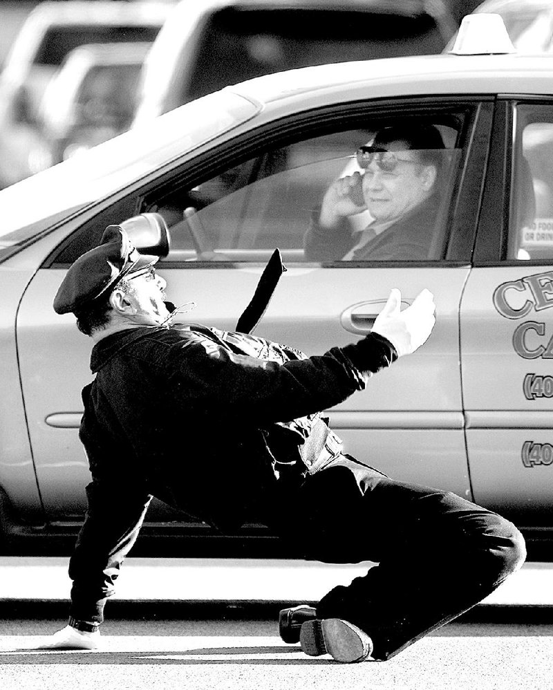 Tony Lepore shows his dance moves as he directs traffic in Providence, R.I., on Dec. 13. 