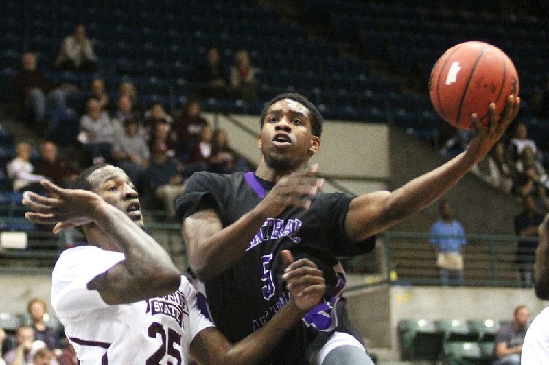 Central Arkansas guard Ryan Williams shoots over a Mississippi State defender during Saturday’s game at the Mississippi Coliseum in Jackson, Miss. Mississippi State won 79-72. 