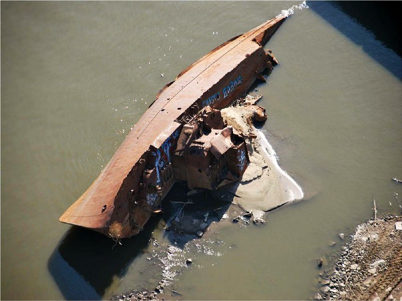 A WWII minesweeper is shown on the Mississippi River near St. Louis in a photo provided by the U.S. Coast Guard. 