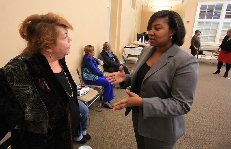 Carrie Raglon (right) of the city of Little Rock and Christine Beems, chairman of the Public Relations Committee of the Central Arkansas Reentry Coalition, talk about a new initiative to help former inmates or homeless people settle into new lives in Little Rock.


