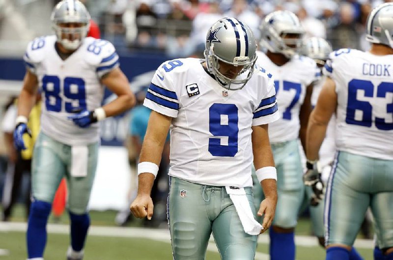 Dallas Cowboys quarterback Tony Romo (9) leaves the field between plays against the New Orleans Saints during the first half of an NFL football game Sunday, Dec. 23, 2012 in Arlington, Texas. (AP Photo/Sharon Ellman)