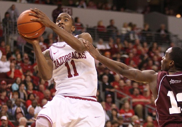 Arkansas' BJ Young drives to the basket  against Alabama A&M's Green Hill during the second half Saturday, Dec. 22, at Verizon Arena in North Little Rock. He finished with 13 points and a career-high 9 assists.