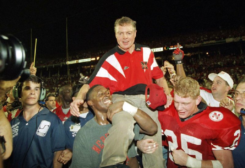 FILE - In this Jan. 1, 1995 file photo, Nebraska players carry coach Tom Osborne off the field after the Huskers defeated Miami 24-17 in the Orange Bowl NCAA college football game in Miami. Osborne will retire as Nebraska's athletic director on Jan. 1, 2013, and end an association with the university that began in 1962. (AP Photo/Doug Mills, File)