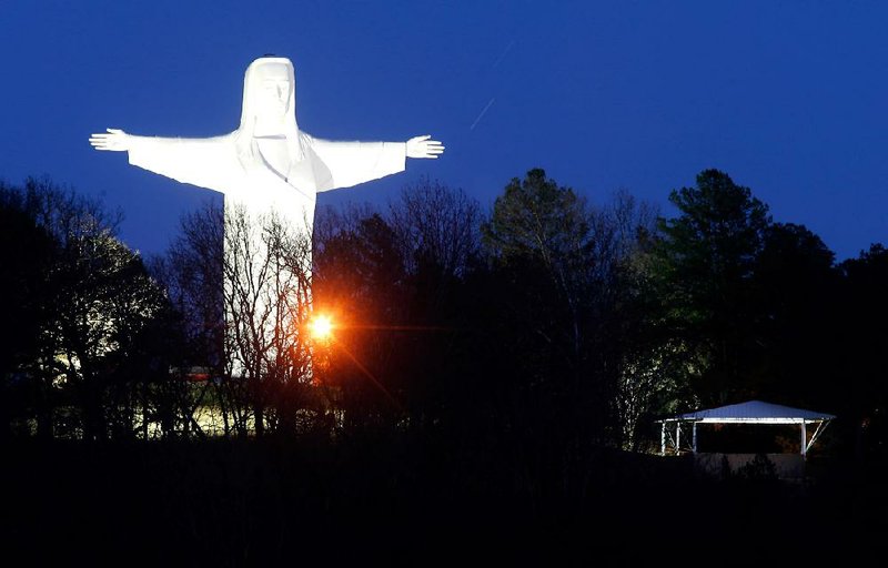 NWA Media/JASON IVESTER
Lights illuminate the Christ of the Ozarks statue on Sunday, Dec. 16, 2012, in Eureka Springs. After the lights were turned off -- the first time since 1967 -- following the closing of the Great Passion Play, donors helped bring the lights back on. The electric bill for the two 10,000-watt floodlights is about $200/month in the winter.