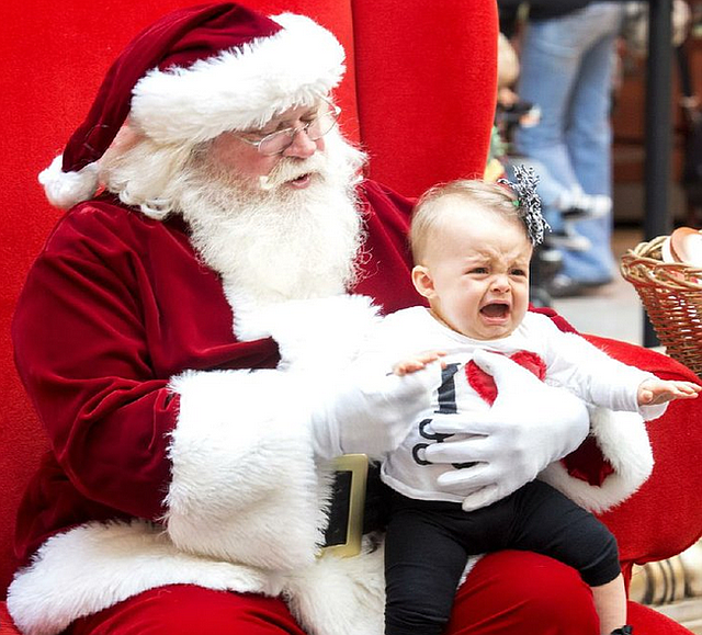 Nine-month-old Carter Chance isn't too happy about having her photo made with Santa Claus at Park Plaza Mall on Monday afternoon.  Afternoon crowds for last minute shoppers was a little lighter than normal at Park Plaza.