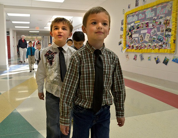 Ethan Bisbee, from front to back, Caden Morse, Dylan Rodles, Leonardo Ortiz, Jesus Nava, Christian Chilian, Jonathan Jimenez and Christian Duenas-Aguilar, Bayyari Elementary School students, walk back to their classroom Tuesday morning. The school has introduced dressing professionally with Ties on Tuesdays to encourage their students to think about their professional appearance. 