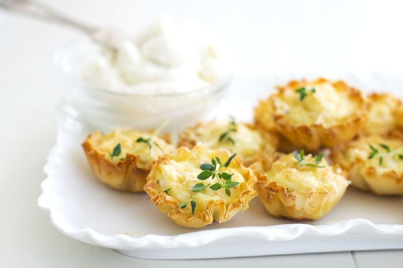 In this undated photo, ricotta cheese creates a rich and creamy base for crab bites perfect for a holiday party as shown served on a tray in Concord, N.H. (AP Photo/Matthew Mead)