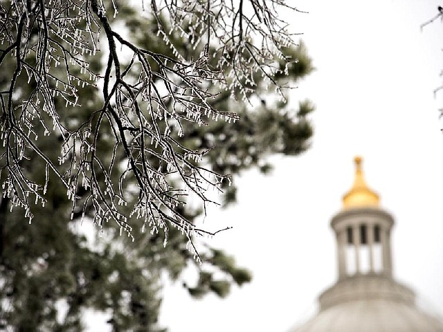  Icicles weigh down the branches of trees on the grounds of the Arkansas State Capitol on Christmas Day. Freezing rain fell over most of Arkansas before a strong winter storm and snow was forecasted to hit Arkansas late Tuesday night.