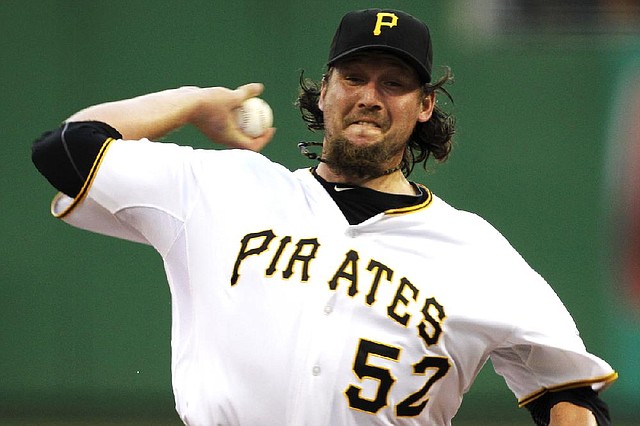 In this July 7, 2012, photo, Pittsburgh Pirates closer Joel Hanrahan delivers during the ninth inning of a baseball game against the San Francisco Giants in Pittsburgh. A person familiar with the talks says the Pirates and the Boston Red Sox are close to completing a trade that would send Hanrahan to Boston for a handful of prospects. Pittsburgh would ship Hanrahan and another player to the Red Sox in exchange for four players, (AP Photo/Gene J. Puskar)