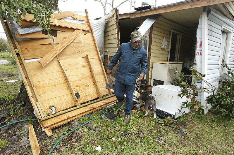 Semler Street resident Mack Robinson checks on his tornado damaged home Wednesday, Dec. 26, 2012, in Prichard, Ala. Robinson's wife, Mary, was home when the tornado hit. "Nobody got hurt, except my feelings," Robinson said. (AP Photo/AL.com, Mike Kittrell)  MAGS OUT