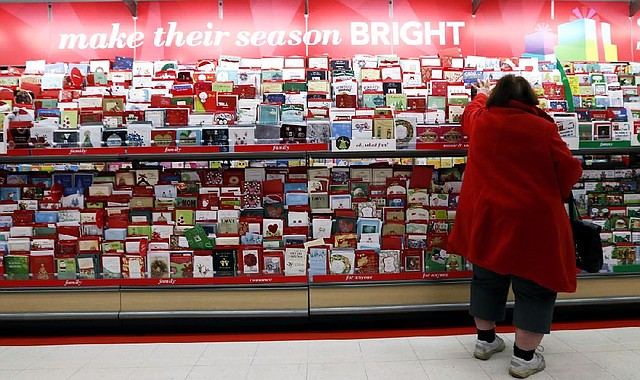 In this Wednesday, Dec. 19, 2012, photo, a customer shops for greeting cards at a Target store in Chicago. U.S. holiday retail sales this year are the weakest since 2008, after a shopping season disrupted by storms and rising uncertainty among consumers. A report out Tuesday, Dec. 25, 2012, that tracks spending, called MasterCard Advisors SpendingPulse, says holiday sales increased 0.7 percent. Analysts had expected sales to grow 3 to 4 percent. (AP Photo/Nam Y. Huh)