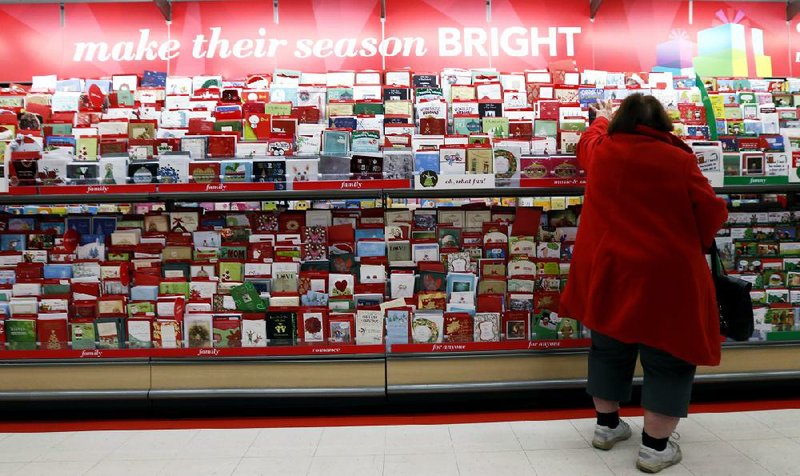 In this Wednesday, Dec. 19, 2012, photo, a customer shops for greeting cards at a Target store in Chicago. U.S. holiday retail sales this year are the weakest since 2008, after a shopping season disrupted by storms and rising uncertainty among consumers. A report out Tuesday, Dec. 25, 2012, that tracks spending, called MasterCard Advisors SpendingPulse, says holiday sales increased 0.7 percent. Analysts had expected sales to grow 3 to 4 percent. (AP Photo/Nam Y. Huh)