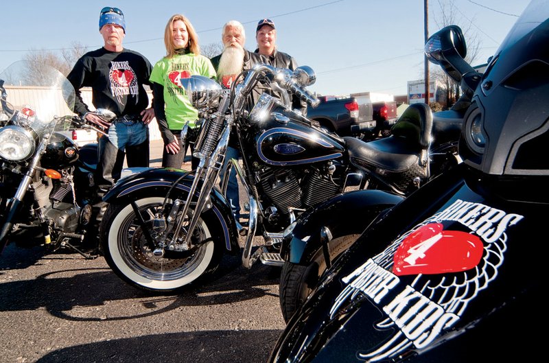 From the left, Phil Bridges and Faran Hearyman, with Terry and Carla Bridges, are members of Bikers 4 Foster Kids, which has been raising money and gathering donated items for Searcy-area foster kids for the past two years. In the upcoming year, the group hopes to expand the organization to include nonbikers as well.