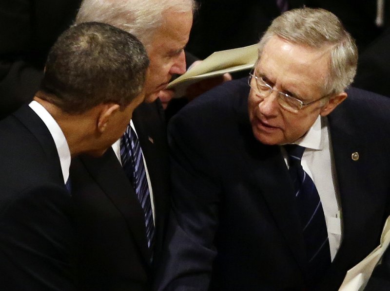 President Barack Obama talks with Senate Majority Leader Harry Reid of Nevada at the funeral service for the late Sen. Daniel Inouye, D-Hawaii, at the Washington National Cathedral, Friday, Dec. 21, 2012. At center is Vice President Joe Biden. 