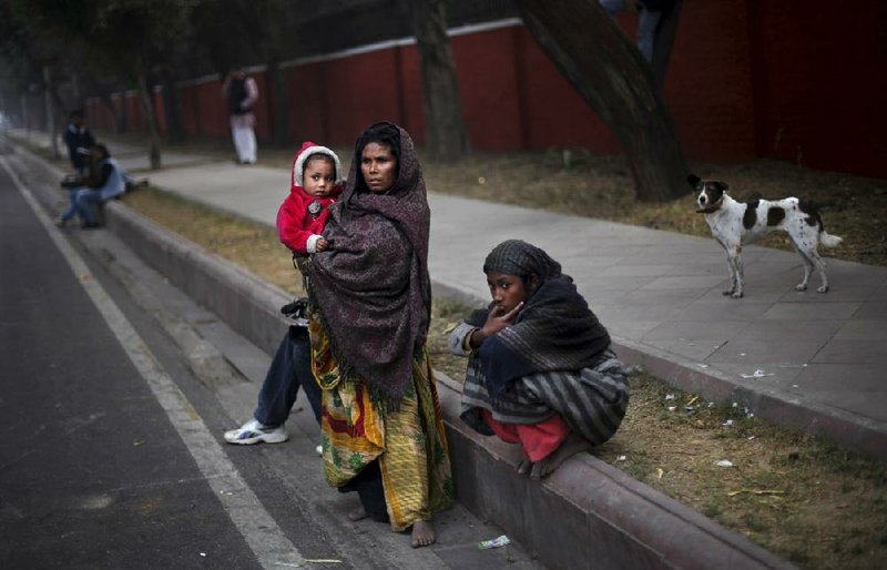 Indians watch a protest Thursday over a recent gang-rape of a woman on a bus in New Delhi. 