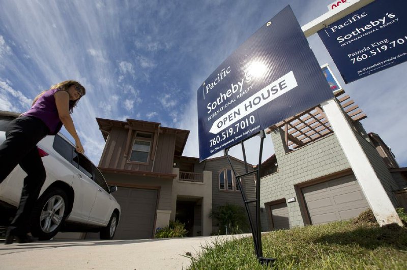 A woman walks to a home for sale in November during a viewing for brokers in Leucadia, Calif. Sales of new homes rose 4.4 percent in November from October, the Commerce Department said Thursday. 