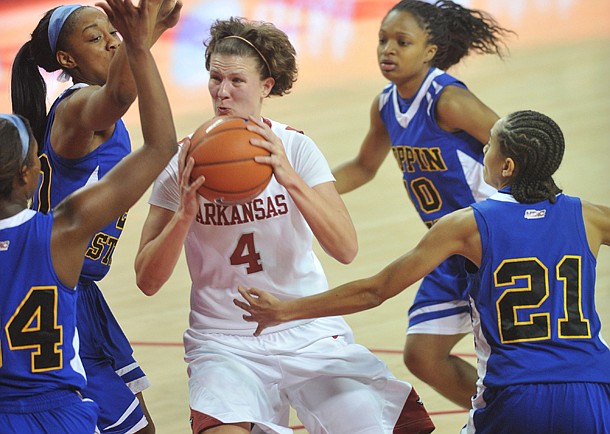 Arkansas forward Sarah Watkins drives to the hoop between Coppin State defenders (left to right) LArrisa Carter, Kyra Coleman, Amber Grifin and Shawntae Payne during the first half of Friday night's game at Bud Walton Arena in Fayetteville.