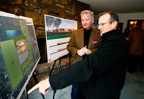 Mike Luttrell of Springdale and property owner Tom Lundstrum, left, look over the proposed site Dec. 20 for a new Walmart Supercenter to be on Elm Springs Road near the intersection with North 48th Street. While Walmart and other legacy companies are important to the region’s economy, they cannot continue to expand at the same pace, economic experts say. 