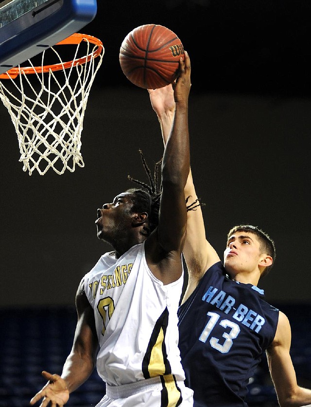 Hot Springs’ Robert Moss (left) attempts a layup as Springdale Har-Ber’s Brandon Buccheri defends Friday in Hot Springs. 